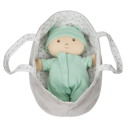 The Wilberry Baby Doll in Green Outfit comes with a white polka-dotted plush basket with handles and a cozy blanket.