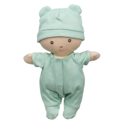 The Wilberry Baby Doll in Green Outfit comes with a basket and blanket. Dressed in light green with a matching bear-ear hat, this soft doll features an embroidered face with brown eyes and a small smile—perfect for snuggles and gentle play.