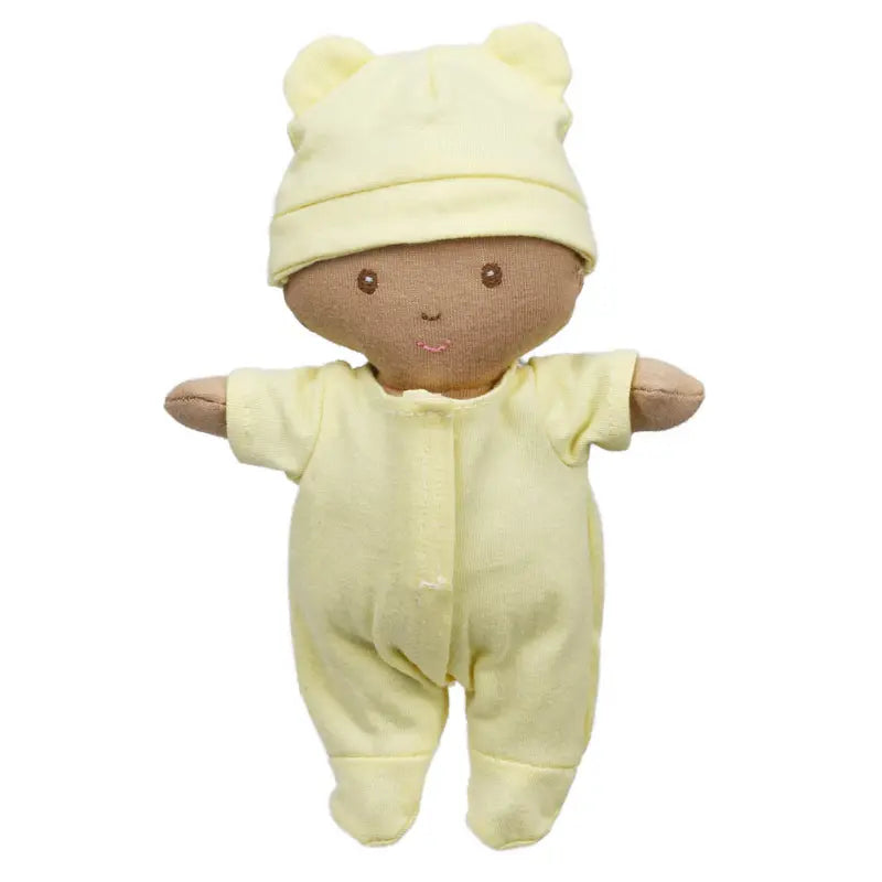 The Wilberry Baby Doll in Yellow Outfit comes with a cozy basket and blanket. Dressed in pale yellow pyjamas and a bear-ear hat, this soft doll has an embroidered face and open arms—ideal for cuddling or napping.