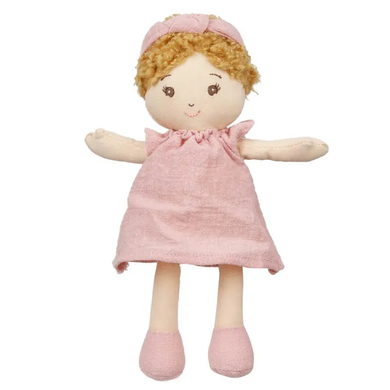 A Wilbery Baby Doll Girl Pink Outfit with curly blond hair, a pink headband, dress, and matching shoes sits upright against a white background.