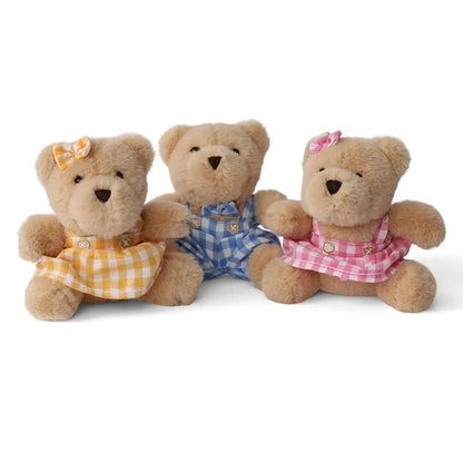 The Wilberry Teddy Bears’ Picnic Soft Toy Set features three light brown bears in yellow, blue, and pink checkered outfits with matching bows, sitting side by side on a white background—perfect for imaginative play.