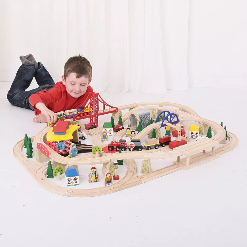 A young boy playing with a Bigjigs Freight Train Set 130 pcs.