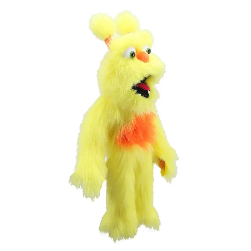 Meet The Puppet Company Yellow Monster: a fluffy yellow hand puppet with orange accents, big green eyes, round ears, and an open mouth standing upright on a white background.
