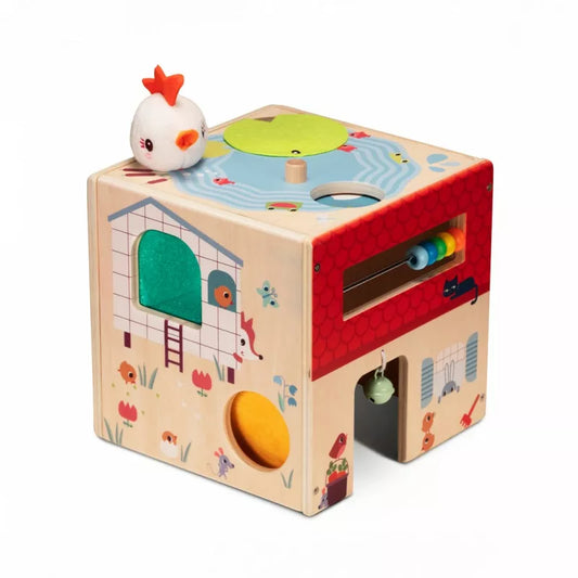 A Lilliputiens Wooden Activity Cube Farm with a bird on top of it.