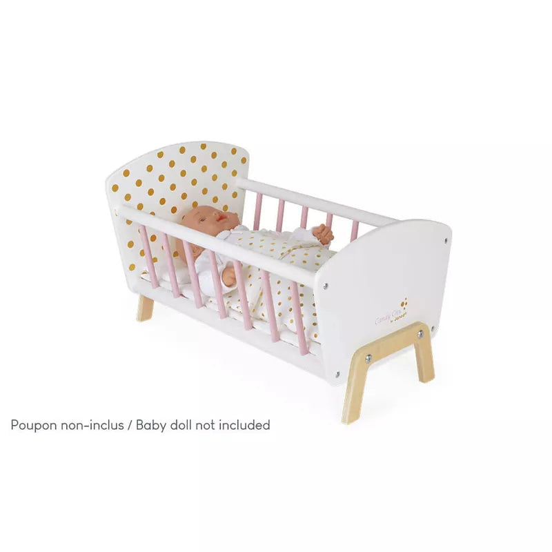 A wooden baby crib with a baby in it.