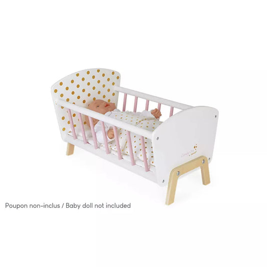 A wooden baby crib with a baby in it.