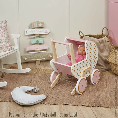 A baby sitting in a Janod Candy Chic Doll's Pram.