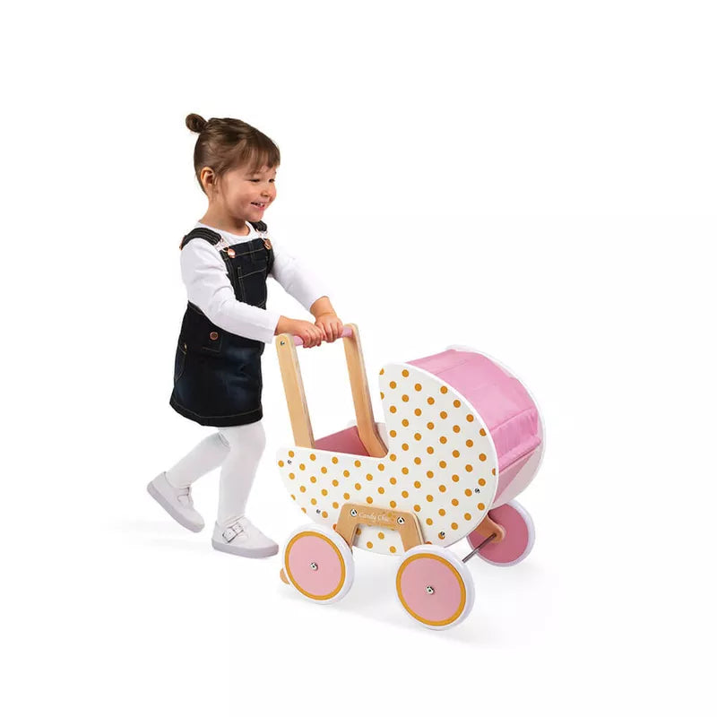 A little girl pushing a Janod Candy Chic Doll’s Pram.
