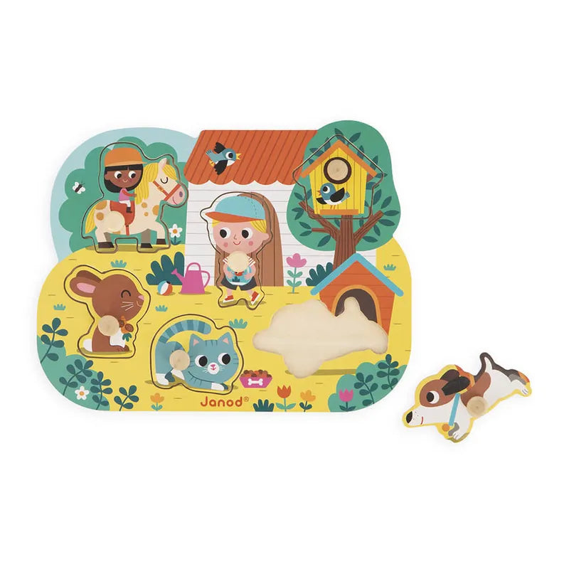 The Janod Country Puzzle Peg Puzzle is a colorful wooden puzzle depicting a farm scene with a house, girl, boy on a horse, cat, rabbit, and birdhouse. Designed for toddlers to enhance fine-motor skills, it includes a removable dog piece amid its charming ensemble.