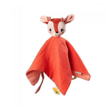 A soft, orange, deer-shaped security blanket featuring a cute, smiling deer head with large ears and white spots on its forehead. Made from organic jersey comforter fabric, it includes a small fabric fish tag in one corner and can be personalized with a customisable name tag: the Lilliputiens Stella the Fawn Comforter.