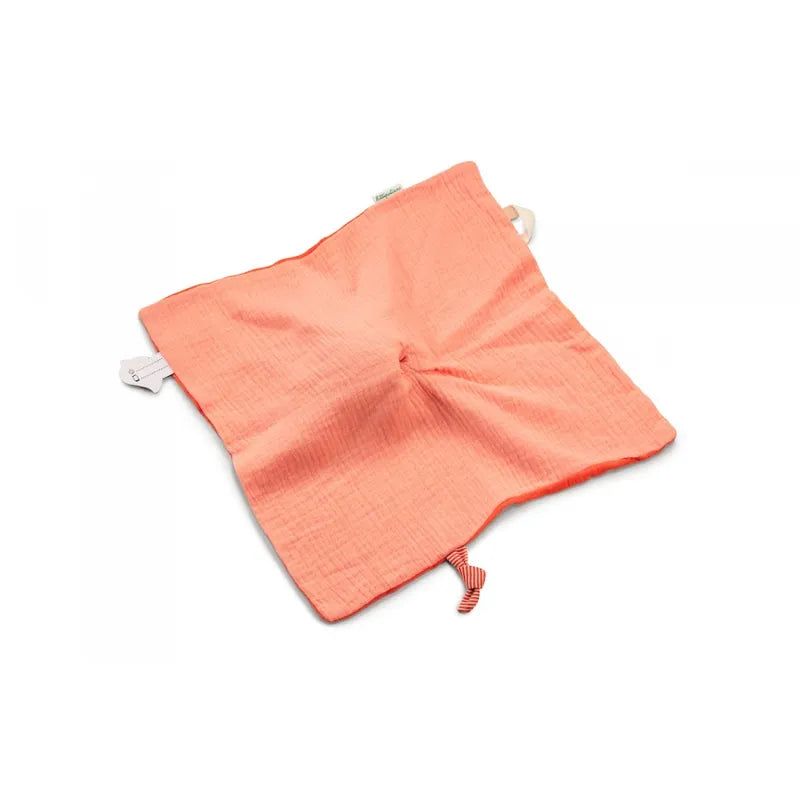 A square-shaped, coral-colored Lilliputiens Stella the Fawn Comforter made of soft, crinkled fabric. The edges are slightly frayed and there is a striped fabric loop along one edge. This perfect birth gift also features an organic jersey touch, with a small knotted detail at its center for added charm.