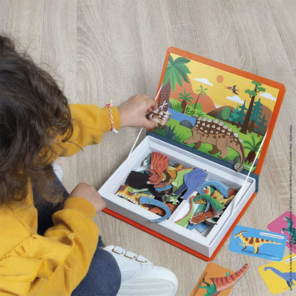 A little girl playing with the Janod Dinosaurs Magneti'Book.