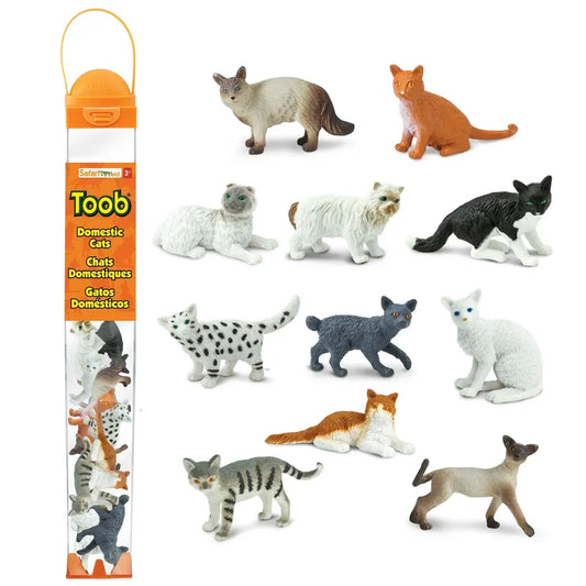 A collection of small plastic cat figurines in various poses and colors, packaged in a clear tube labeled "TOOB® Figurines Domestic Cats.