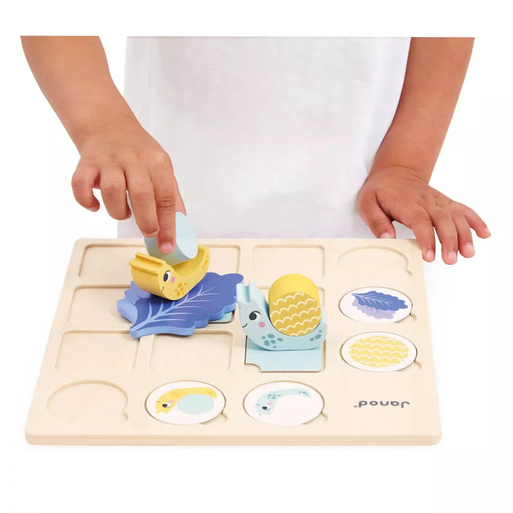 A child is playing with a Janod Double Entry Table Snails.