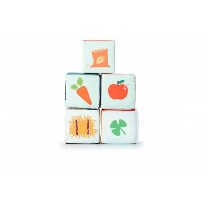 A stack of Lilliputiens Farm House Stacking Cubes with fruits and vegetables on them.