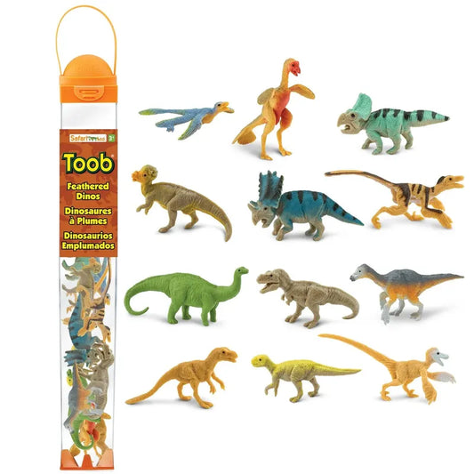 A collection of twelve hand painted TOOB® Figurines Feathered Dinos displayed next to their packaging labeled "feathered dinos" by Safari Ltd. The dinosaurs vary in species and colors, emphasizing detailed feathers and textures.