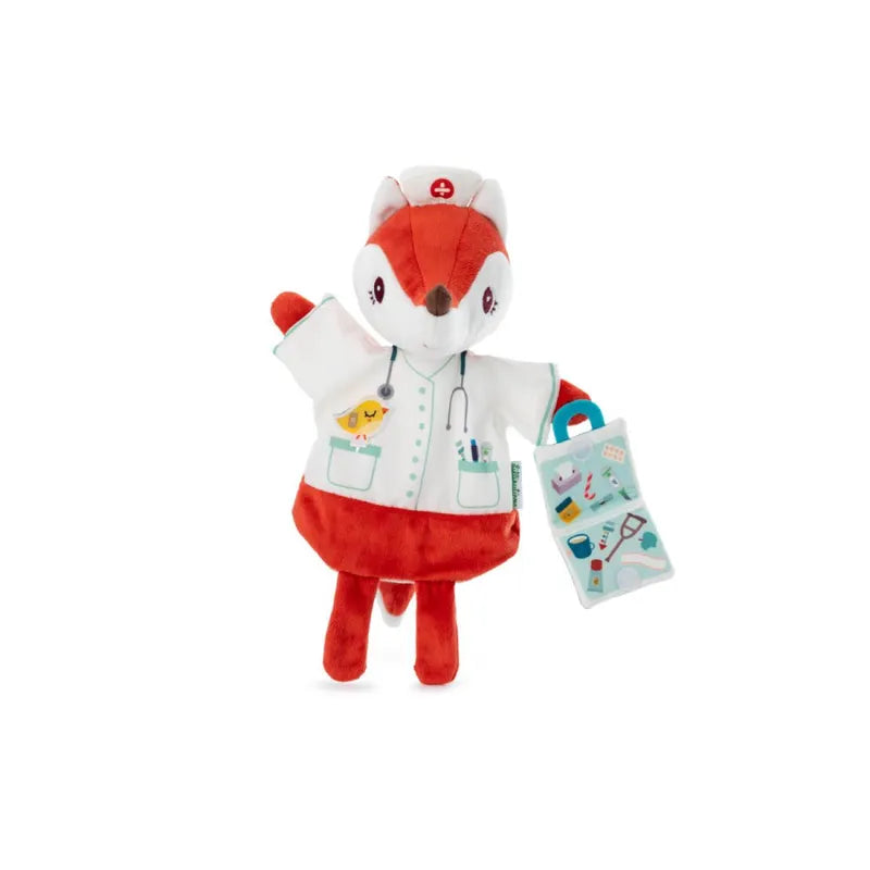 A Lilliputiens Alice Doctor Handpuppet dressed as a nurse, wearing a white coat with pockets, a stethoscope around its neck, and a red nurse hat with a white cross. Perfect for imaginative play, this machine washable fox holds a teal medical bag adorned with various medical equipment illustrations.