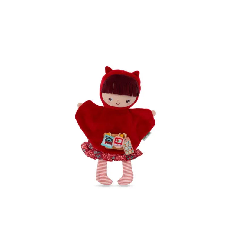 A Lilliputiens Red Riding Hood Handpuppet dressed in a red hooded cape with small horns, a colorful skirt, and striped leggings. The puppet has a small, embroidered face with a friendly expression and holds soft toys resembling buildings, perfect for young children to enjoy imaginative play as they recreate adventures akin to Little Red Riding Hood Hand Puppet tales.