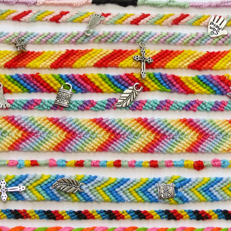 A group of Buttonbag Friendship Bracelet Kits with charms on them.