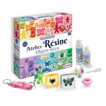 The "Sentosphere Resin Workshop" craft kit provides an enjoyable DIY experience. It includes vibrant molds, resin bottles, a pipette, decorative inclusions, and finished items such as a butterfly and keychain—showcased elegantly on a white background.