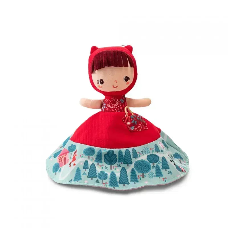 The Lilliputiens Little Red Riding Hood Reversible Storydoll is a plush doll dressed as Little Red Riding Hood, featuring a red hood and dress. The skirt of her dress is beautifully patterned with teal and blue trees, a small house, and other forest scenery. This doll serves as an excellent storytelling toy, showcasing a cute face with embroidered features and brown hair.