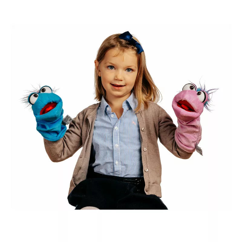 A little girl holding two Living Puppets Tüffelchen Glove Puppets in her hands.
