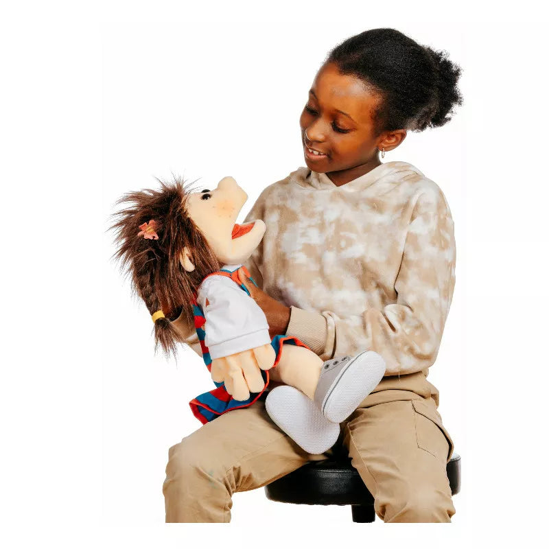 A little girl sitting on a chair holding a Living Puppets Lischa Hand Puppet 45cm.