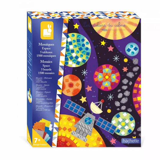 Introducing the Janod Mosaics Space art kit, packaged in a brightly colored box. The front showcases a completed space-themed mosaic featuring a satellite, planets, and stars set against a dark purple background. The box is labeled "Les ateliers du calme" and includes contents such as 5 boards and 1500 mosaics. This kit is suitable for ages 7 and up, making it an ideal gift for aspiring astronauts.