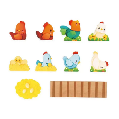 Introducing the Janod Farm - My First Chicken Coop: a charming set featuring cute, colorful hen and chick figures. The collection includes two red hens, one green rooster, one white hen with chicks, two yellow chicks with eggs, one blue and white hen, a yellow nest with eggs, and a wooden plank—a delightful toddler educational toy perfect for imaginative play.