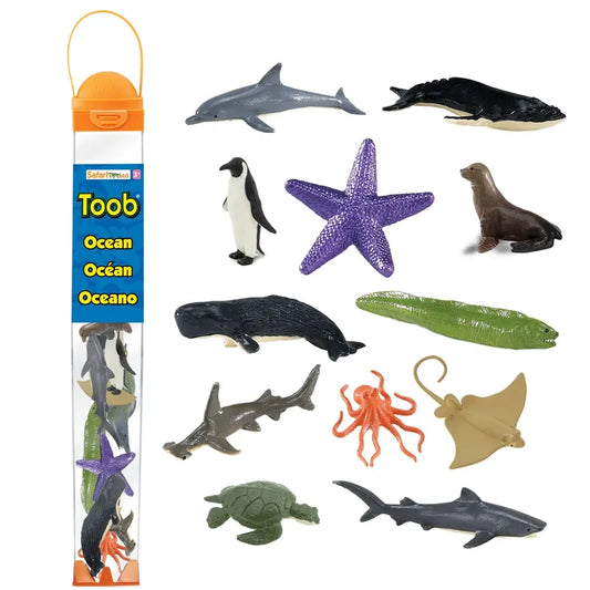 Sentence with the replaced product name: Product image showing a collection of plastic marine figurines including dolphins, whales, a penguin, sea star, seal, octopus, and a turtle, packaged in a transparent TOOB® Figurines Ocean.