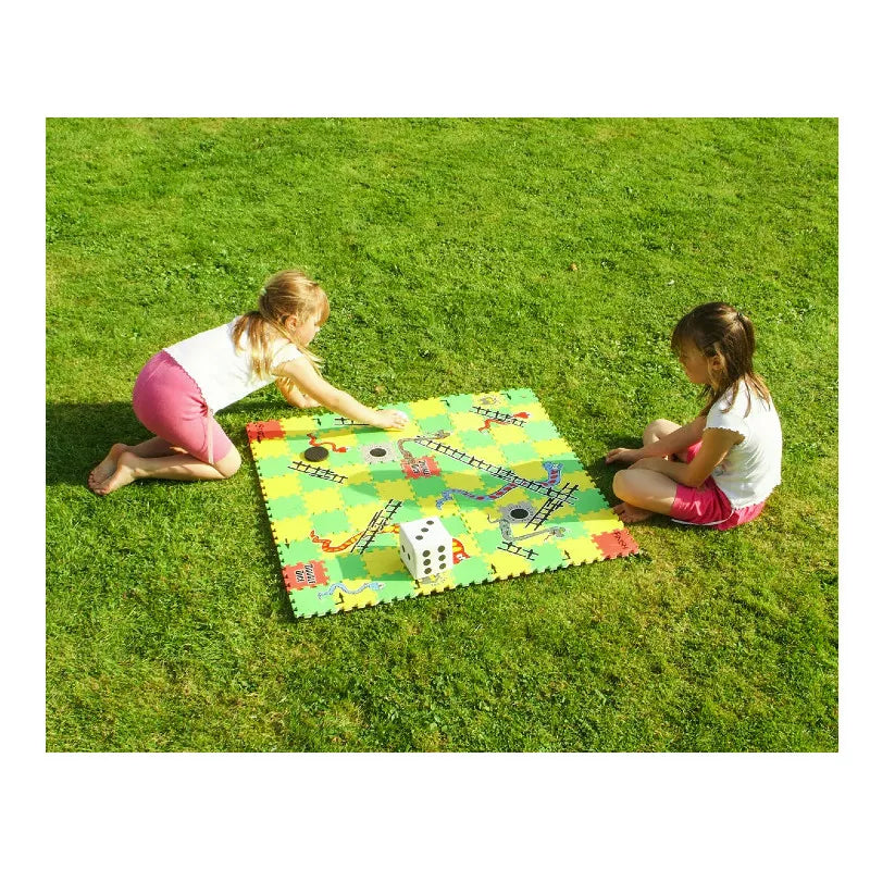 Two girls playing with 5 Big Games in One Set on the grass.