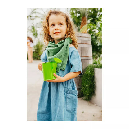 A little girl is holding a Plant and Garden Set.