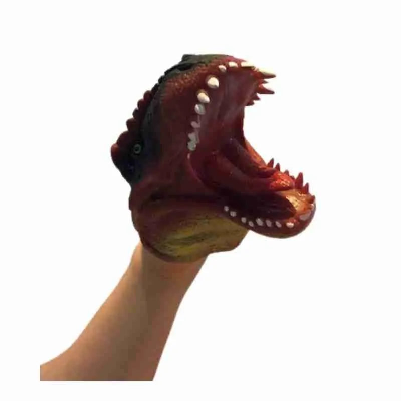 A Schylling Dinosaur Hand Puppet Red is holding a fake dinosaur head.