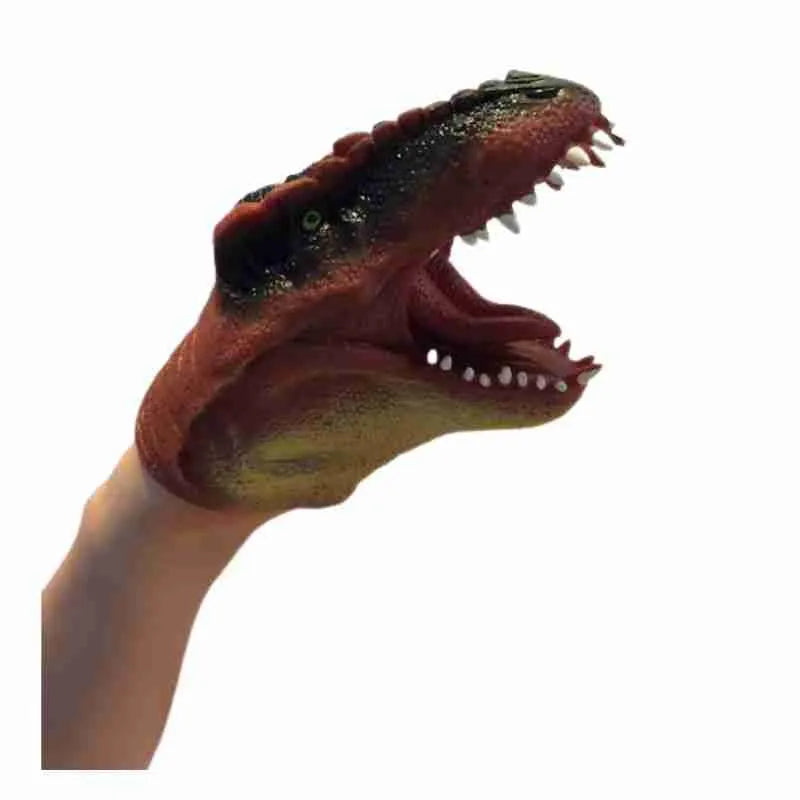A close up of a person's hand holding a Schylling Dinosaur Hand Puppet Red.