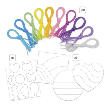 The Janod Scoobies String Decorations To Make includes an assortment of 10 colored string bundles in shades of blue, green, yellow, pink, and purple arranged in a semi-circle at the top. Below are cut-out templates in shapes like fish, ice cream, heart, and circles, along with pattern design sheets—an ideal birthday gift for 8-year-old artists.