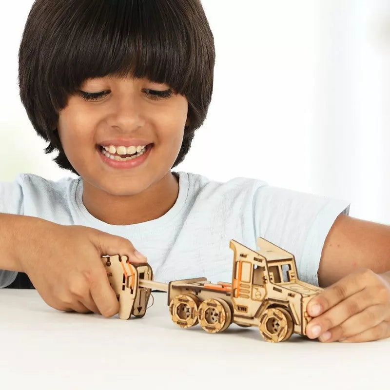 A young boy playing with Smartivity STEM Construction Race Truck.