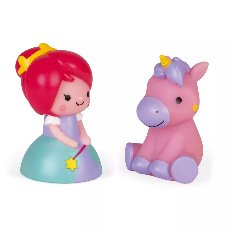 A little girl sitting next to a Janod Squirter Princess & Luminous Unicorn Bath Toy.
