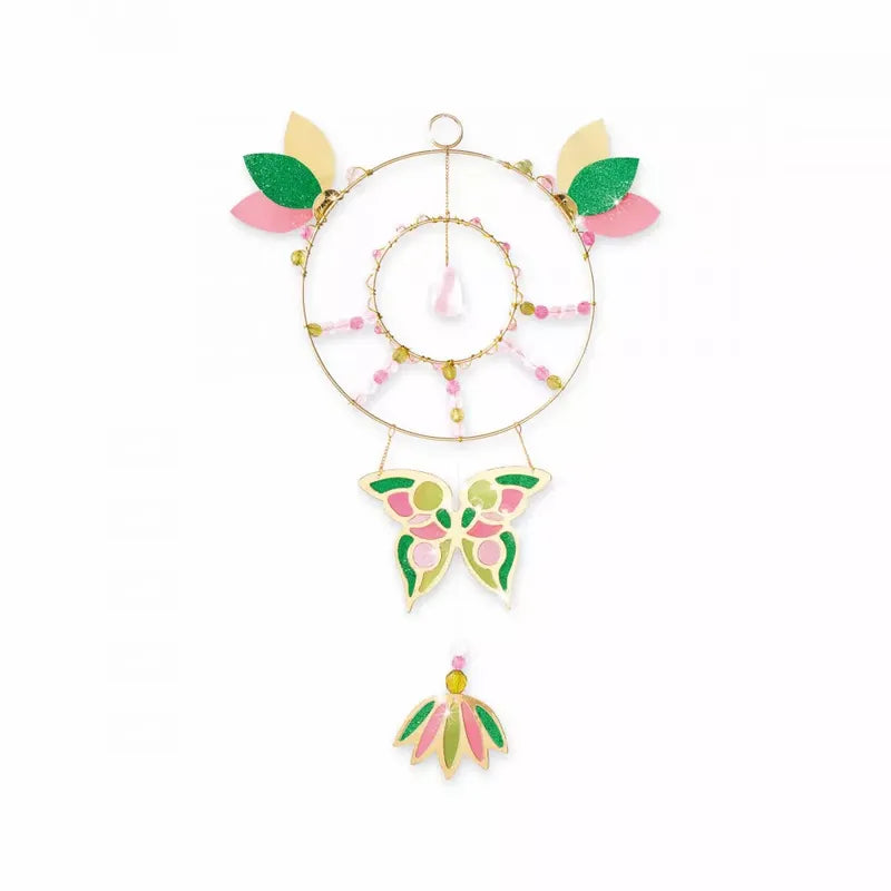 A Janod Suncatcher To Make with a butterfly motif in the center, perfect as a children's craft kit. The suncatcher features pink, green, and yellow leaves and beads, with an additional hanging ornament shaped like a flower. The background is plain white.