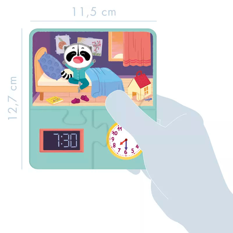 A hand holding an Educational Learn to tell the time clock with a picture of a raccoon on it.