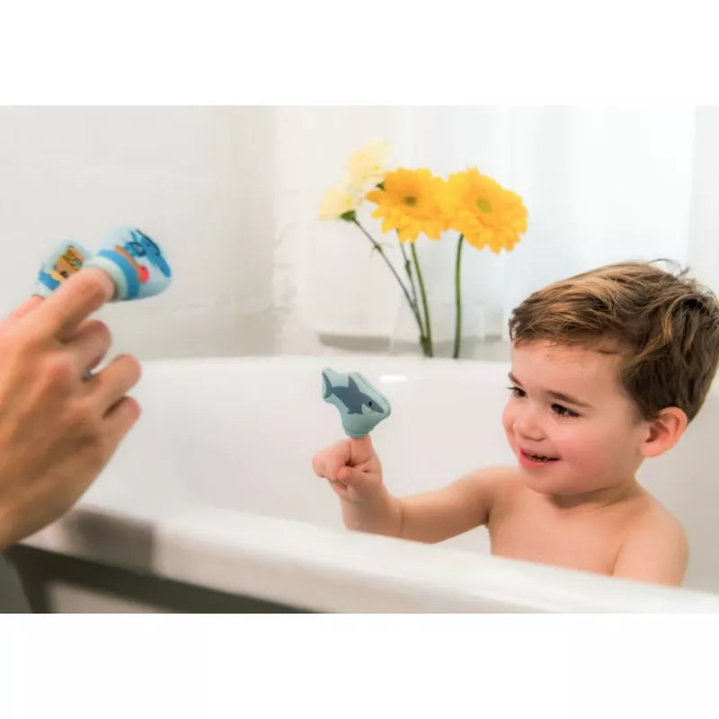 A little boy sitting in a bathtub playing with The Pirates Bath Finger Puppets.