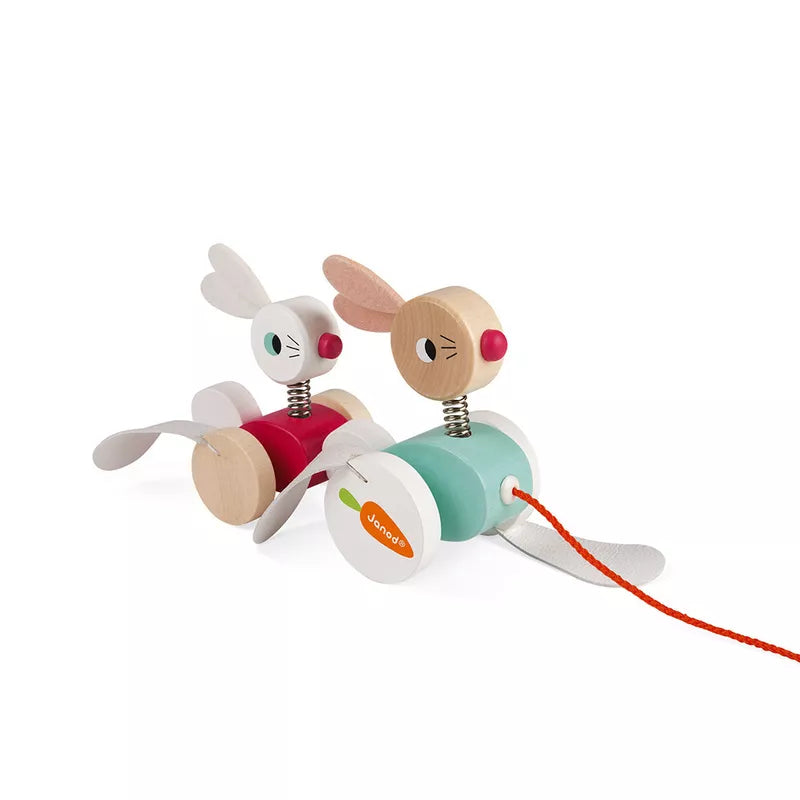 Janod Pull-along Rabbits are a wooden toy rabbit family with a red string that promotes motor skills development.