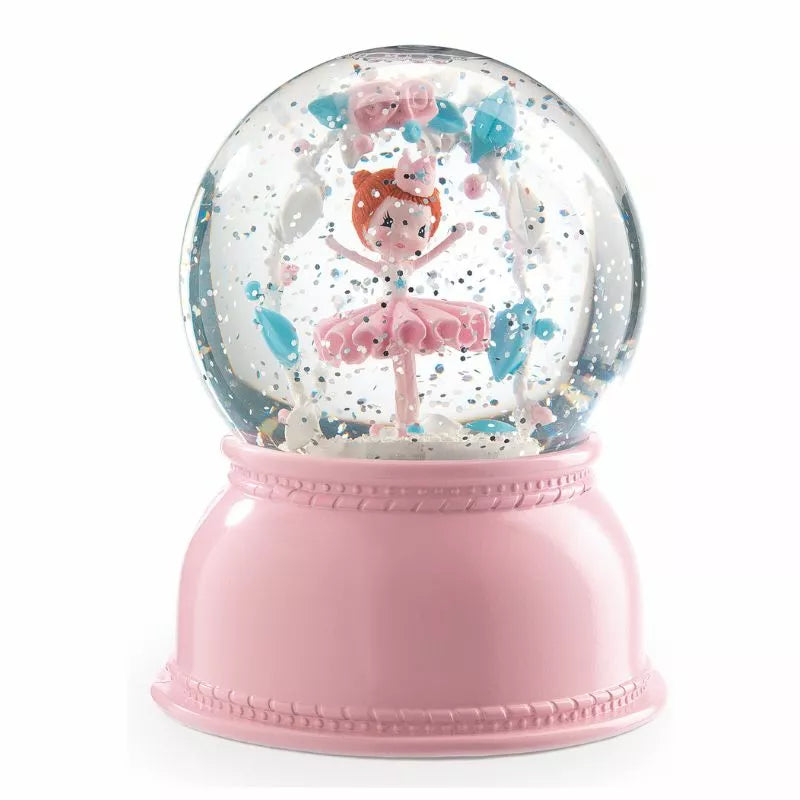 A Djeco Snow Ball Nightlight Ballerina with a little girl in it.