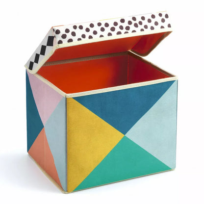 A colorful Djeco Seat Toy Box Geometry with a polka dot lid.