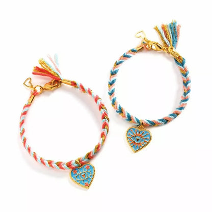 A pair of Djeco Duo Jewels Friendships and Hearts bracelets with charms on them.