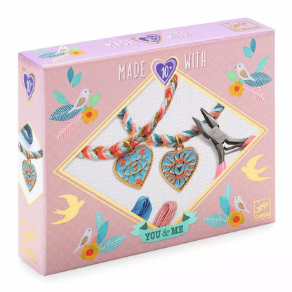 A pink Djeco Duo Jewels Friendships and Hearts box with a pair of scissors and two hearts on it.