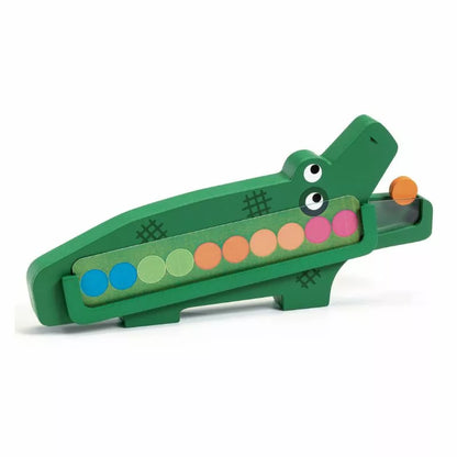 A wooden toy with a green alligator on top of it.