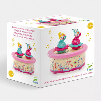 A Djeco Musical Box Flower Melody with two figures on top of it.