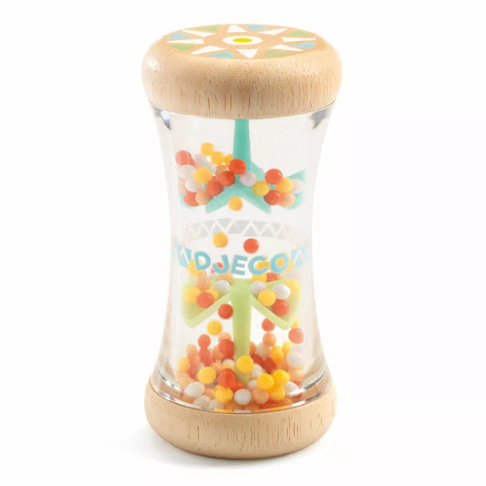 A Djeco BabyPlui jar filled with candies on top of a white table.