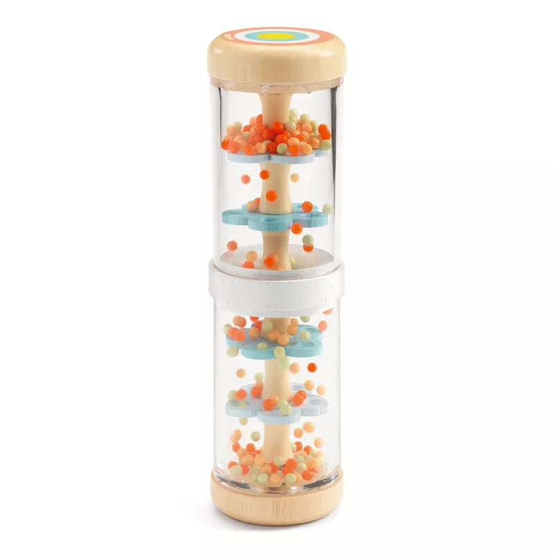 A three tiered Djeco Baby Raini glass container filled with orange and blue candies.