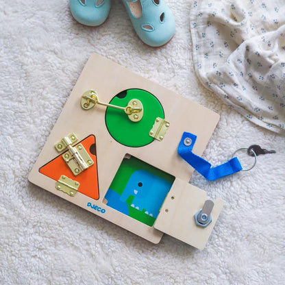 A Djeco Lockbasic Skill Game toy is laying on the floor next to a pair of shoes.